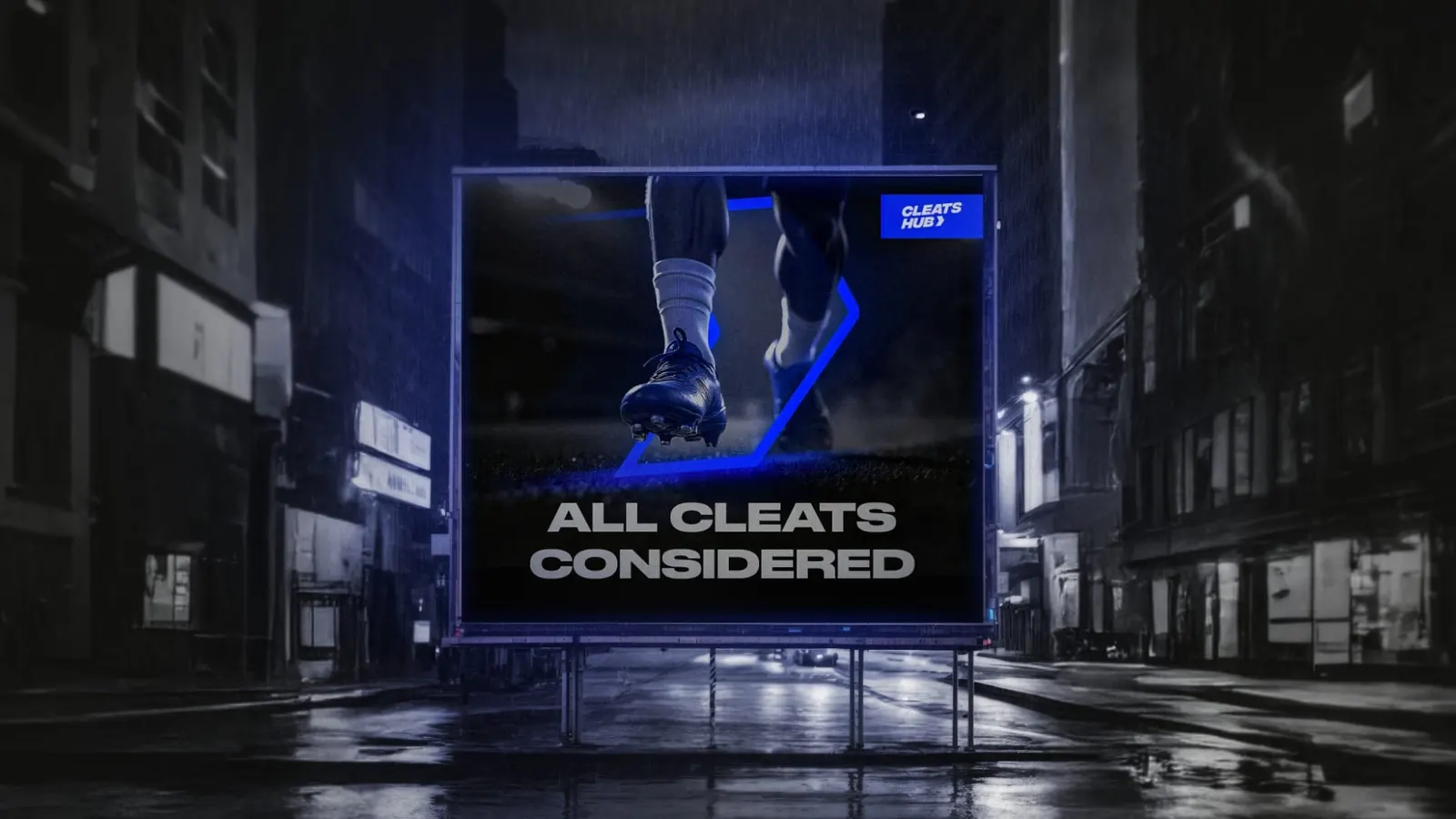 An ‘All Cleats Considered’ billboard on a city street at night